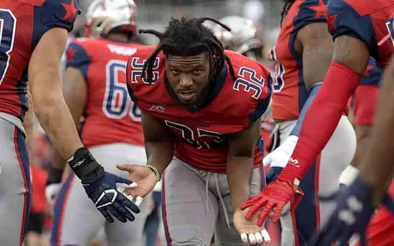 XFL player high fiving with team mates 