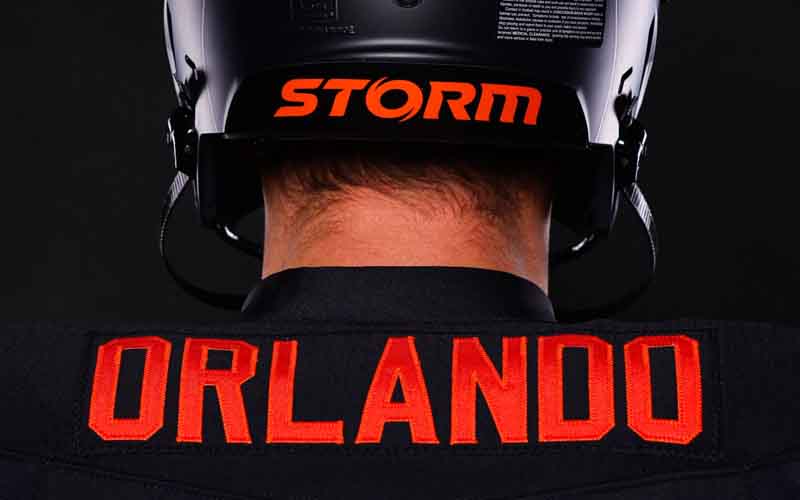 A jersey that has Orlando as the last name and a helmet that says Storm on it, adorned by a model facing away from the camera